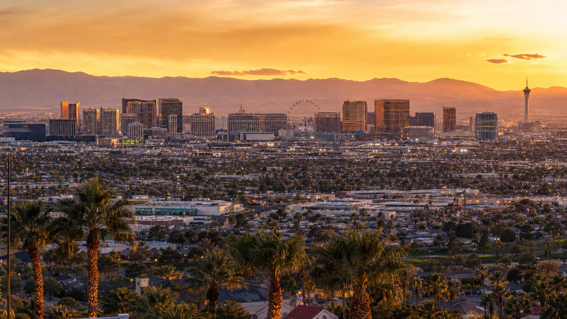 Sunlit aerial view of Las Vegas neighborhoods with the Strip skyline beyond | Las Vegas Relocation Services Sunlit aerial view of Las Vegas neighborhoods with the Strip skyline beyond